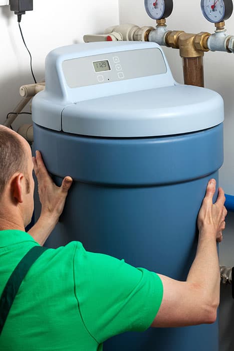 man installing a water softener